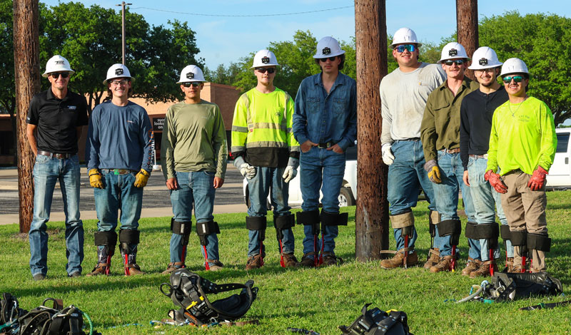 Electrical lineworker repairing connections on an utility pole