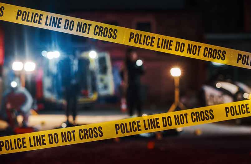 crime scene tape in front of police crime scene