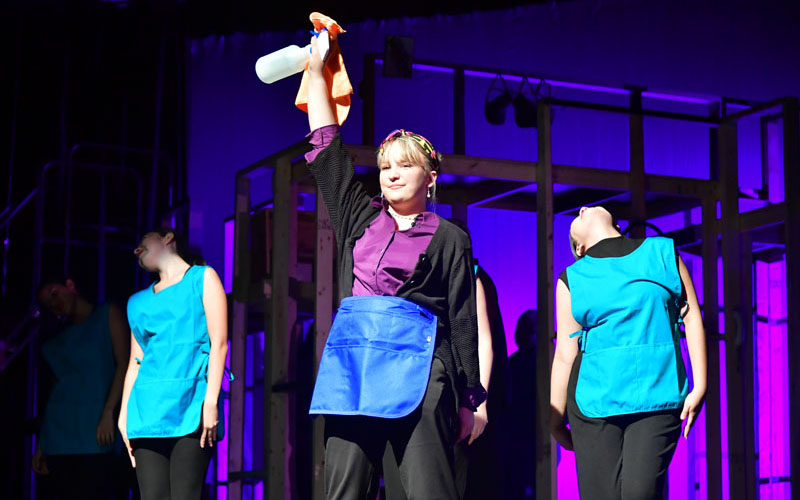 students performing a theatrical show on stage