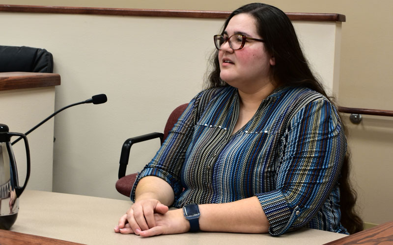 a person in the court room giving a testimony on the stand