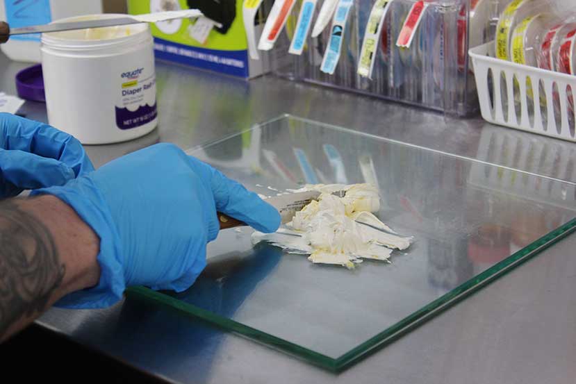 Closeup of pharmacy tech's hands preparing a prescription