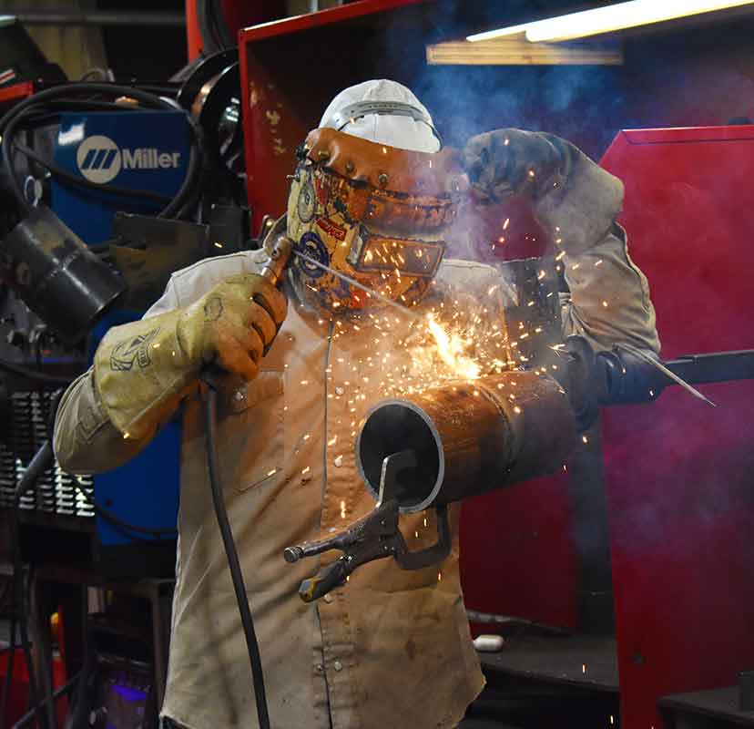 instructor welding a pipe